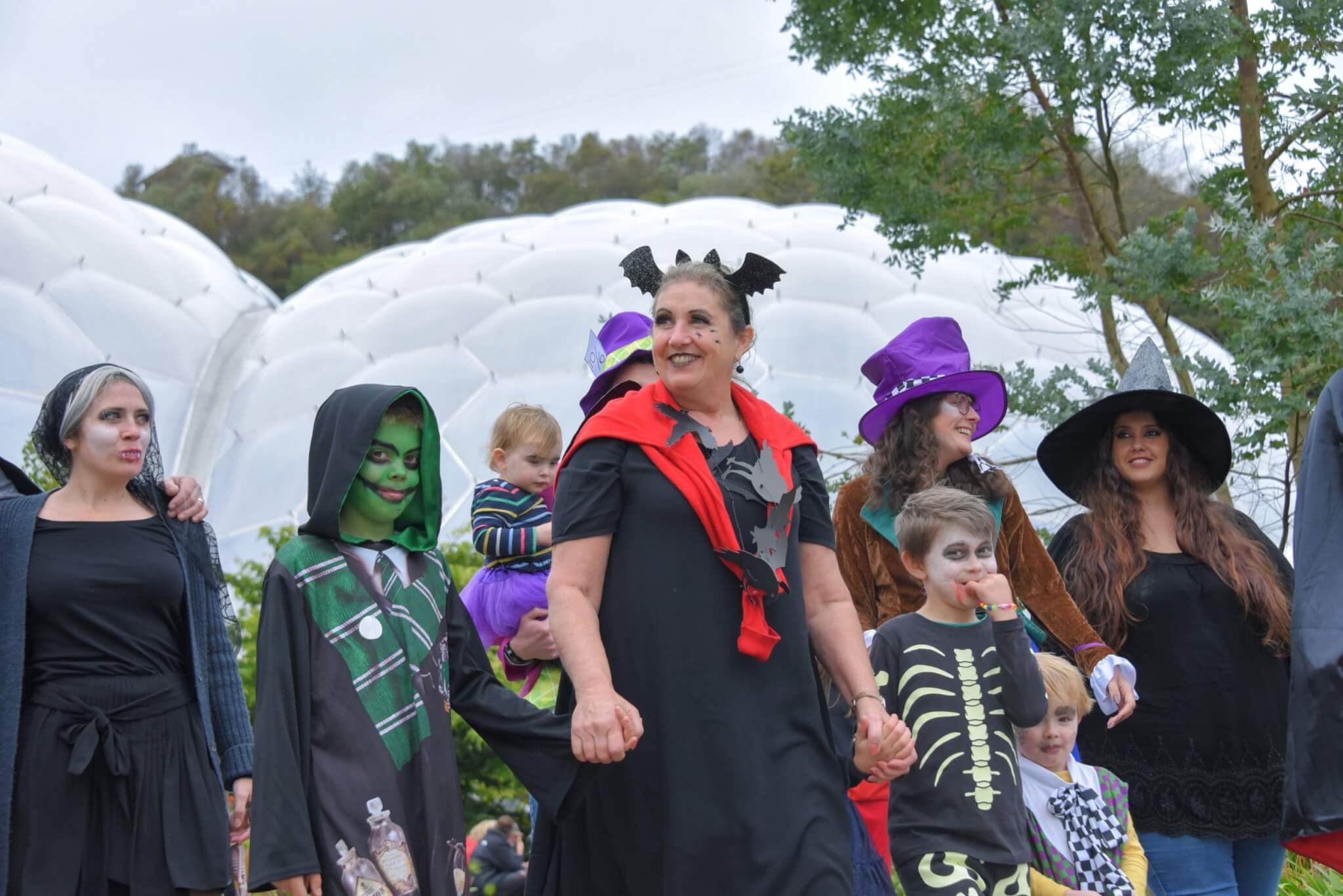 Visitors in Halloween costume outside the Eden Project biomes