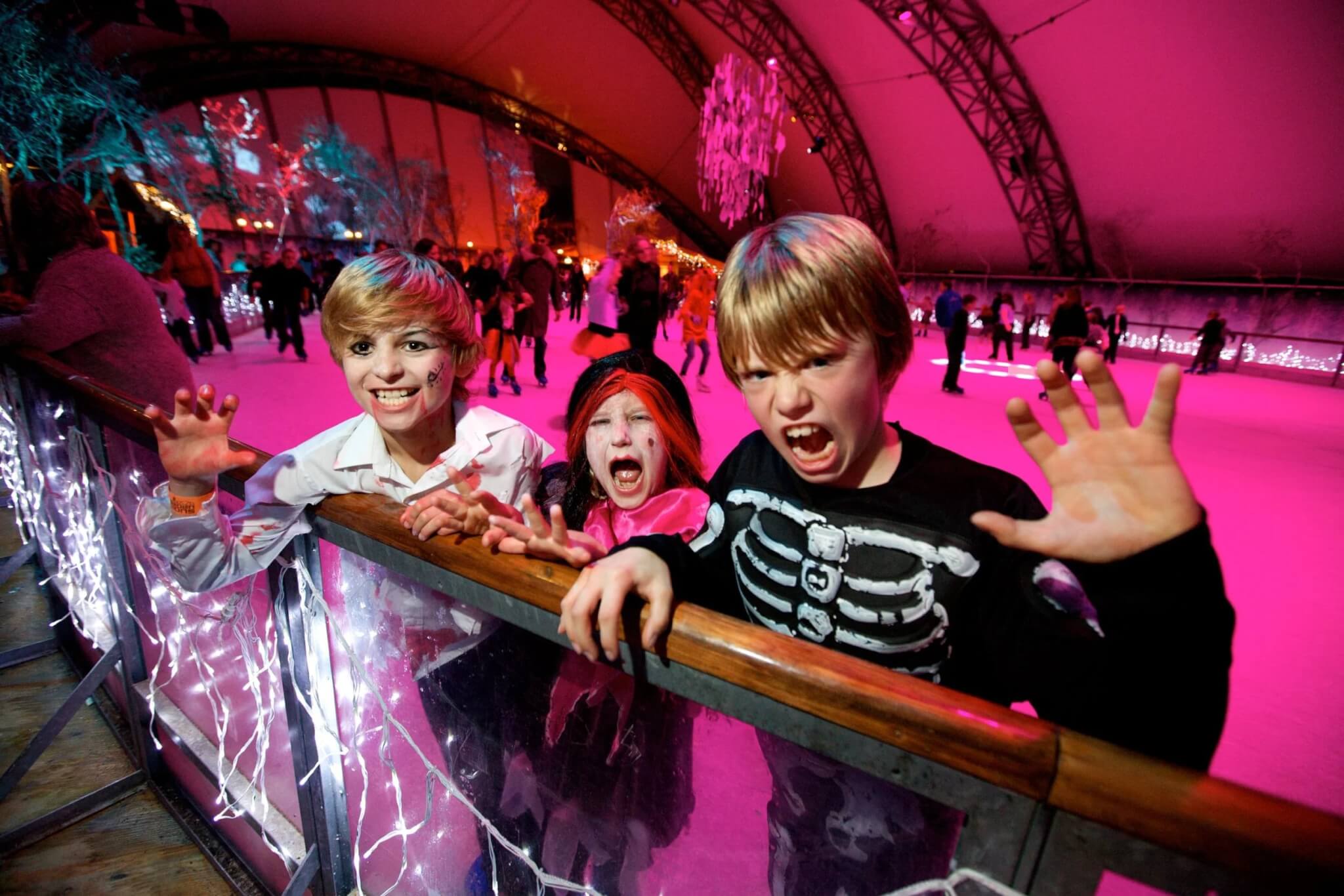 Children on the Eden Project ice rink lit in pink