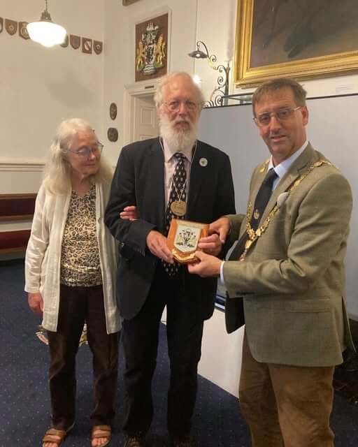 Mayor of Falmouth Cllr Alan Jewell presents Euan McPhee with a Falmouth Town Council plaque