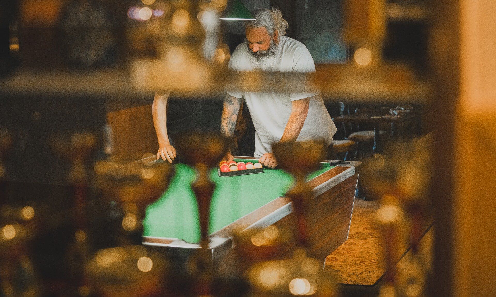 People racking up balls on a pool table in a Falmouth pub