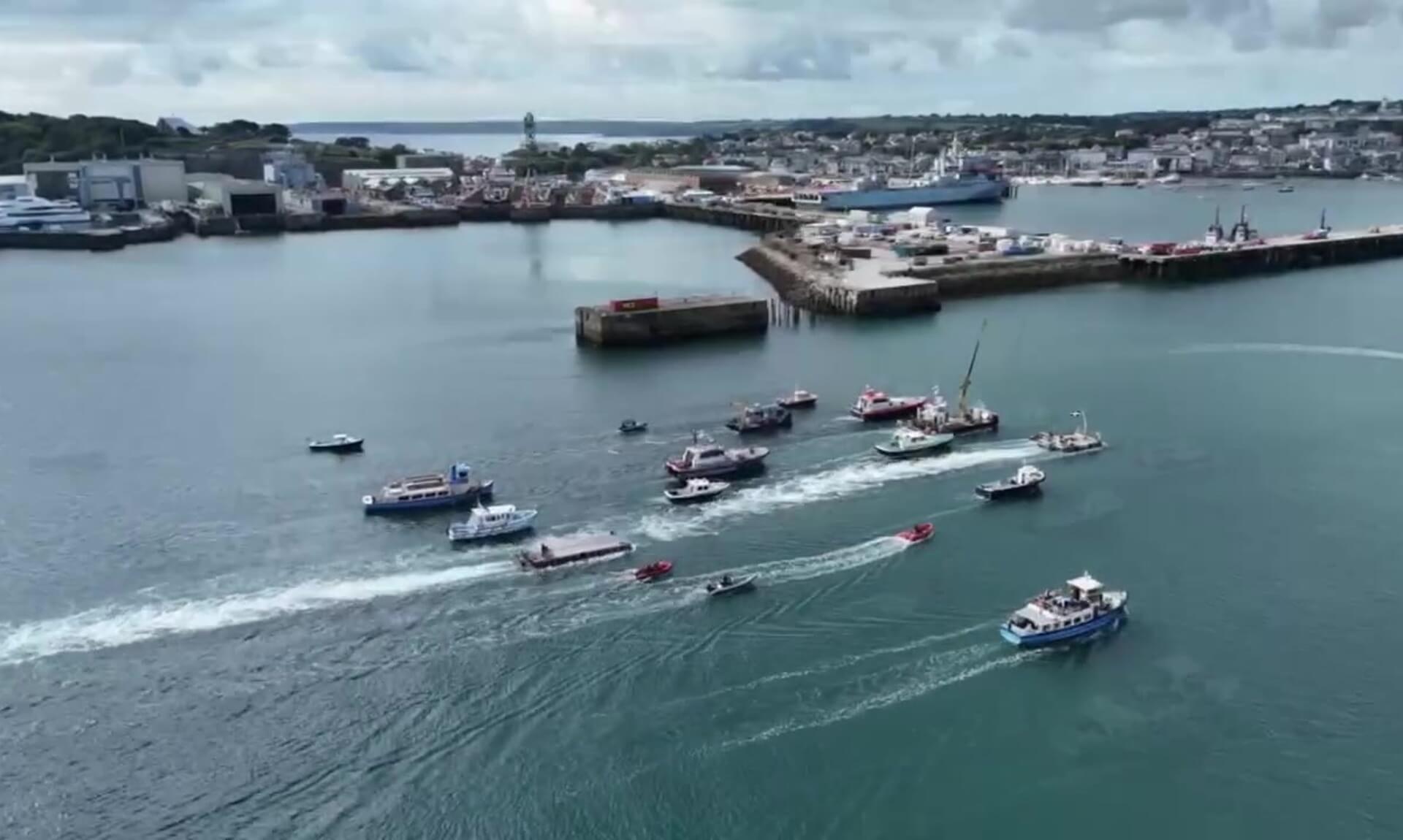 Flotilla of workboats and commercial vessels in Falmouth harbour during the parade of sail