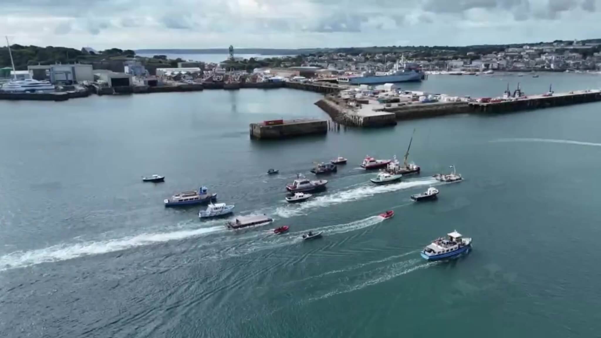 Flotilla of workboats and commercial vessels in Falmouth harbour during the parade of sail