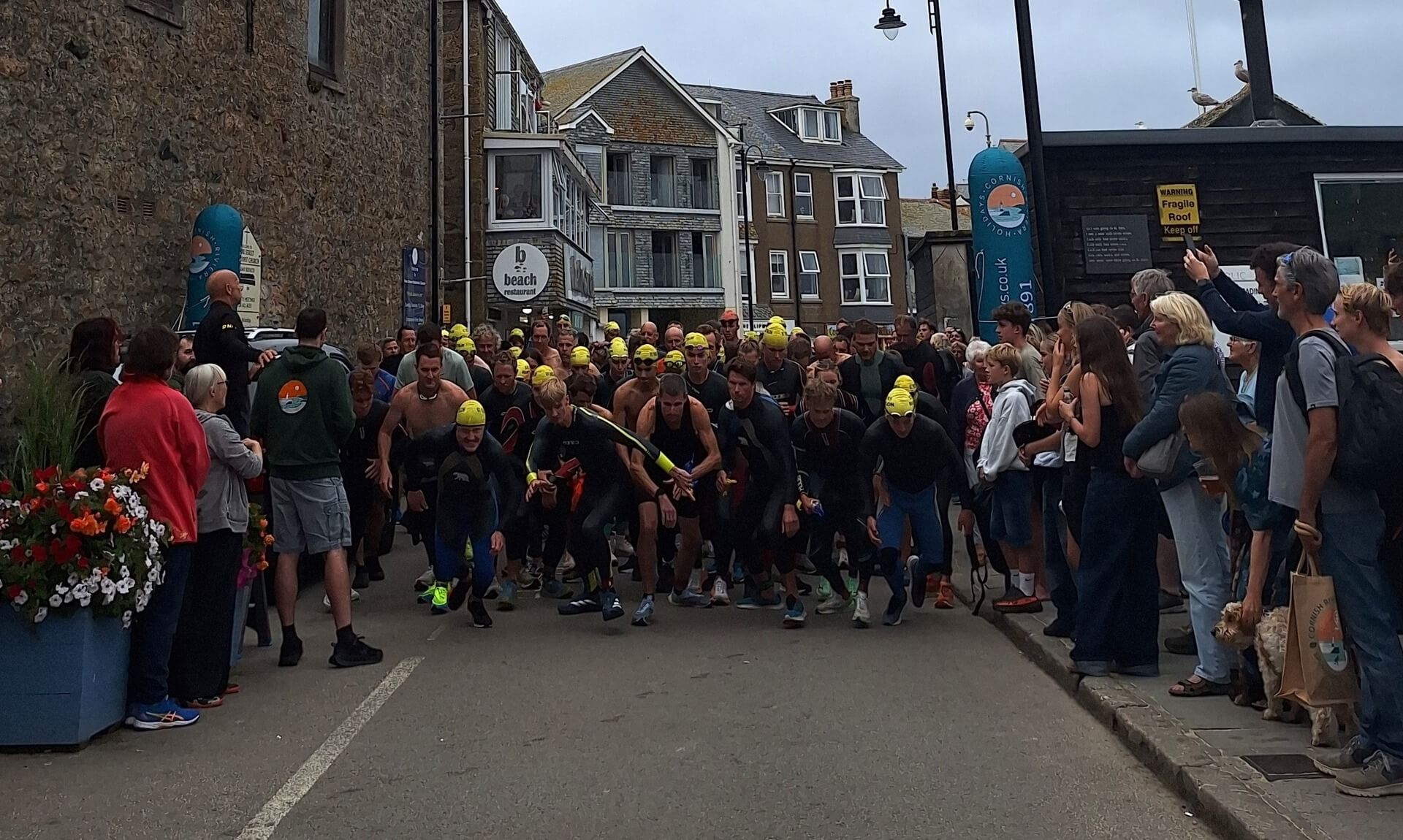 Runners and swimmers set off from the harbour slipway at the start of the St Ives Biathlon
