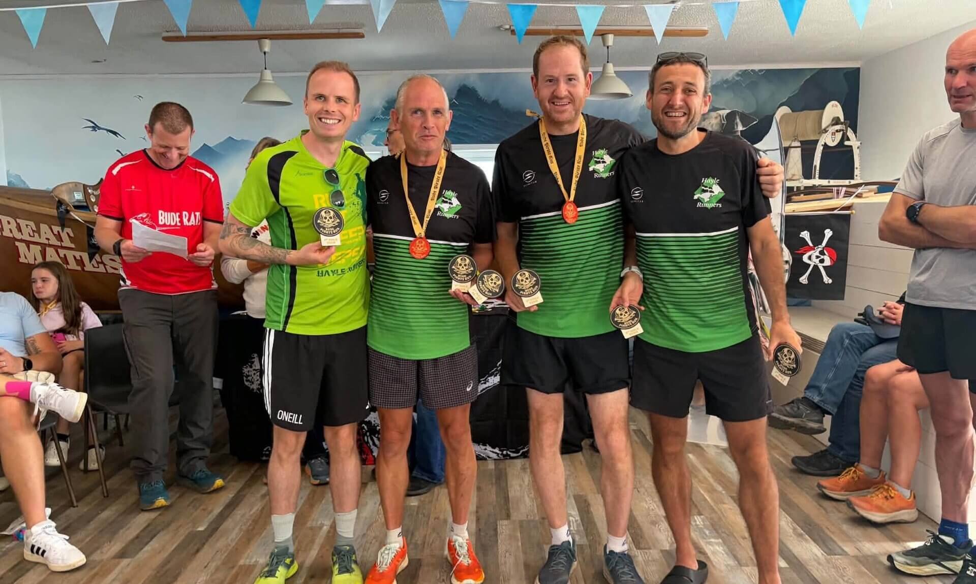 Hayle Runners men's team with their Bude Pirate Run medals and trophies
