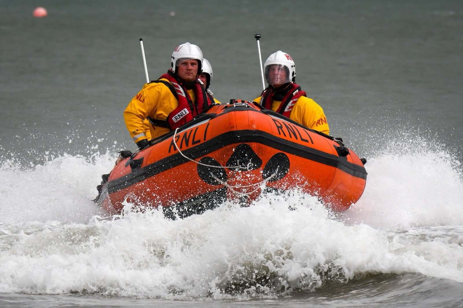 Newquay RNLI lifeboat crew powering through waves during a rescue