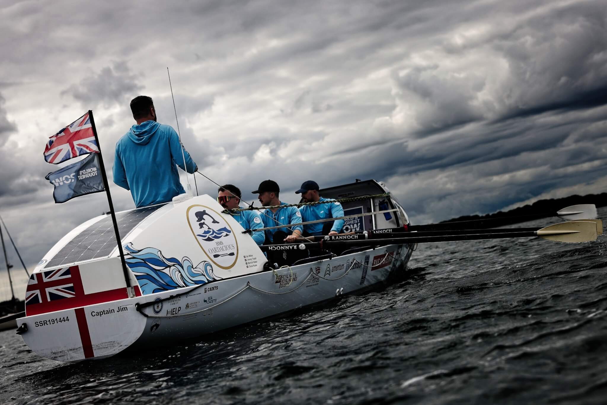 The HMS Oardacious boat under stormy skies