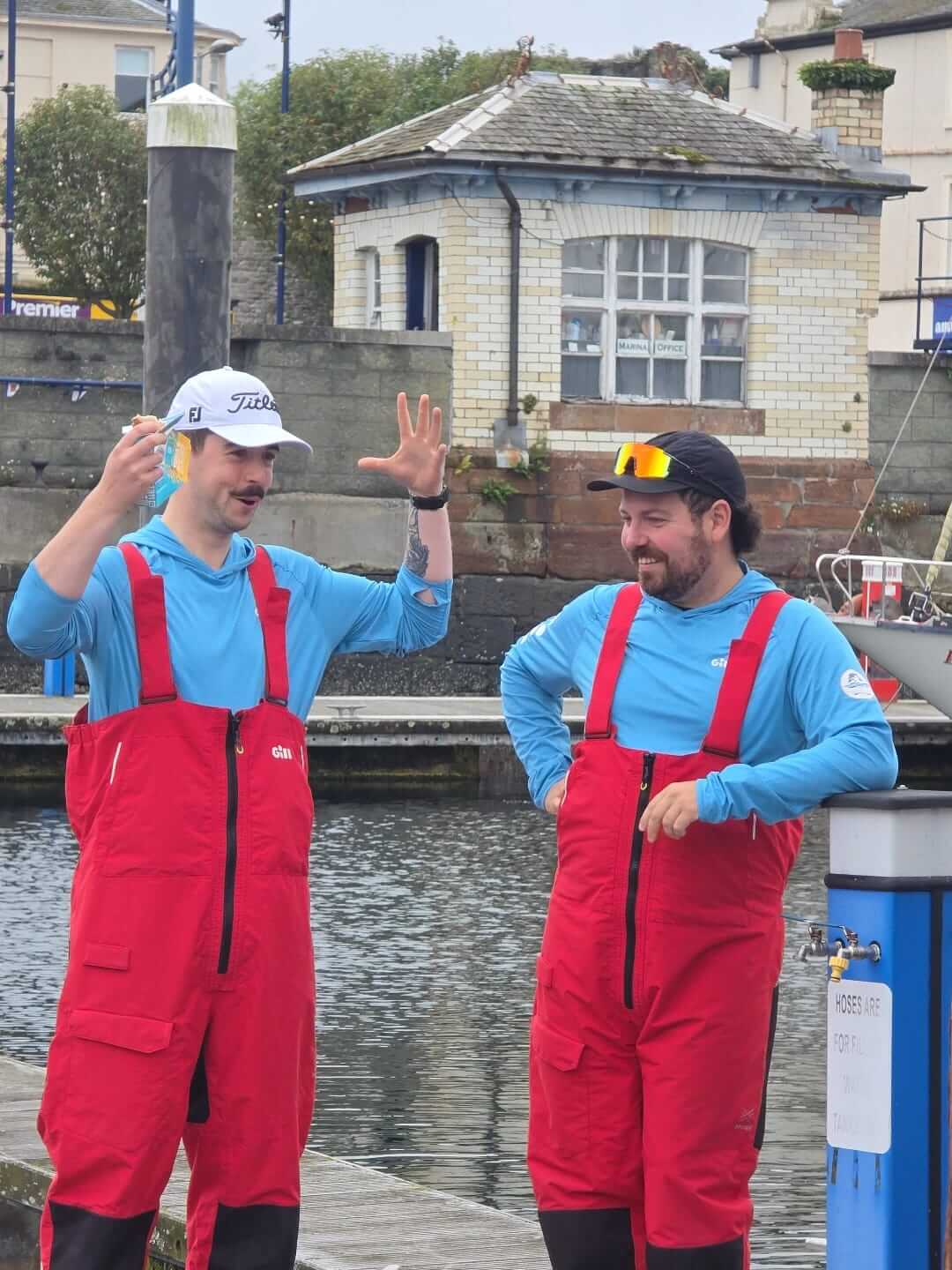 Two crew members on a marina pontoon