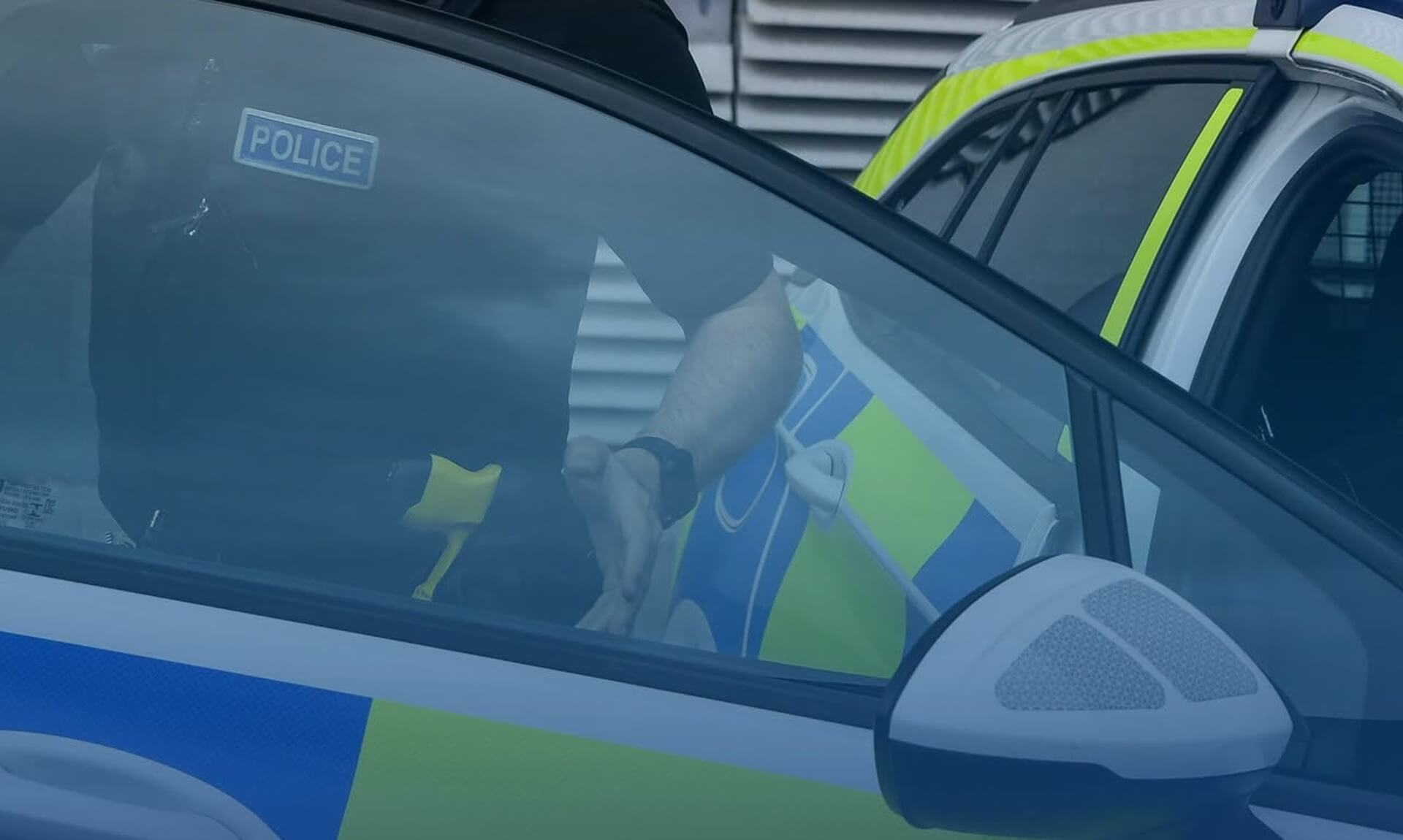 Devon and Cornwall Police officer at a police car
