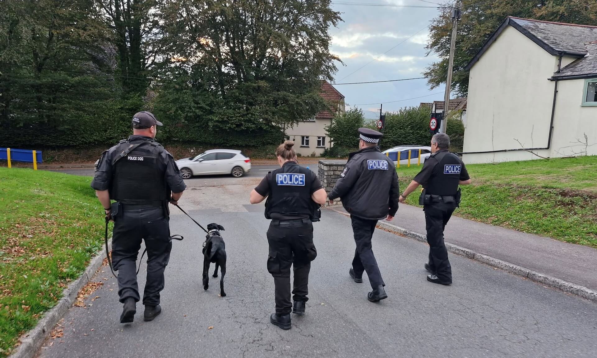 Police officers and passive drugs dog Jasper on patrol