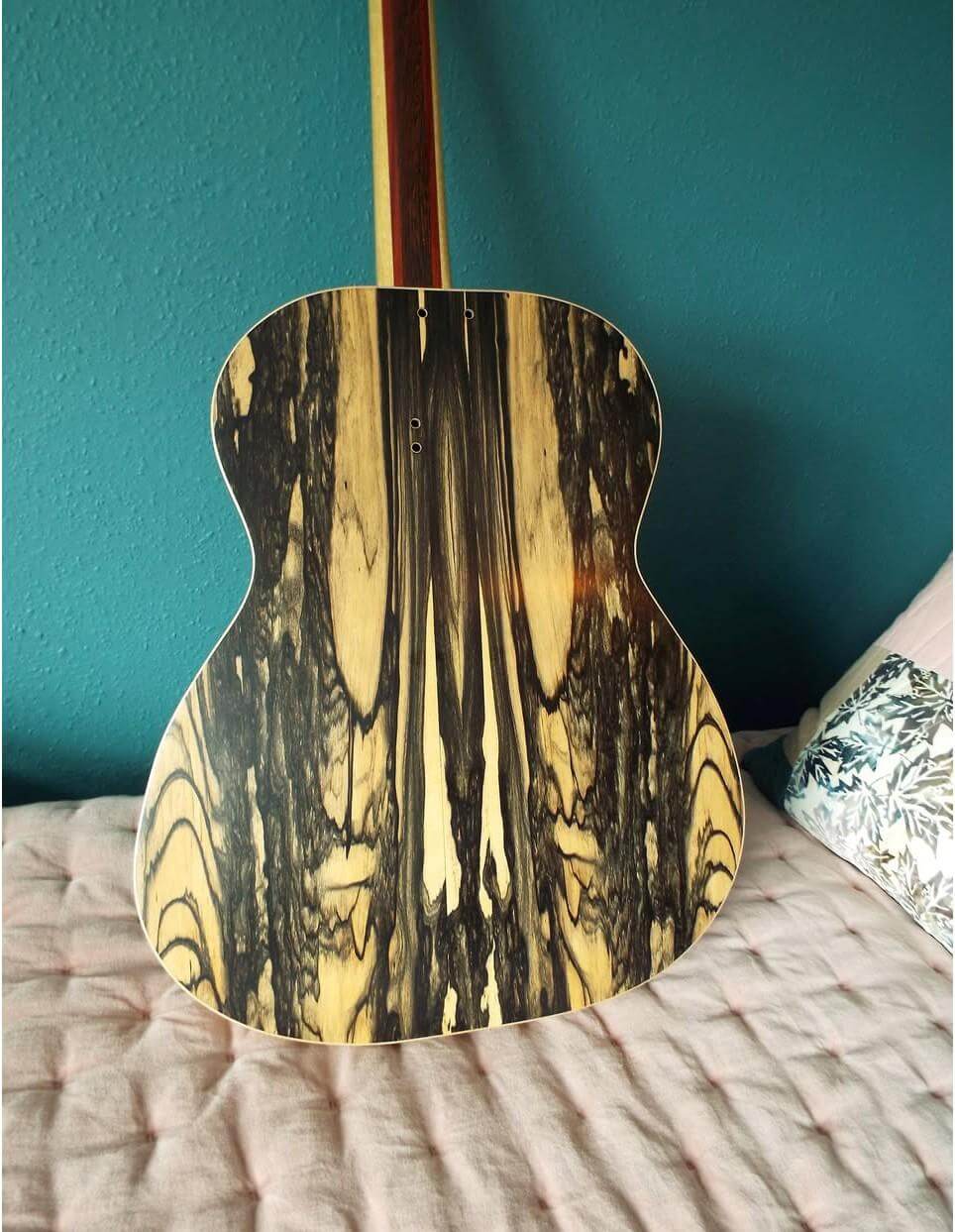 The pale moon ebony back of Kif Wood's handmade guitar, showing dramatic dark and pale wood grain