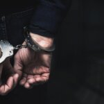 Man in handcuffs with hands behind his back