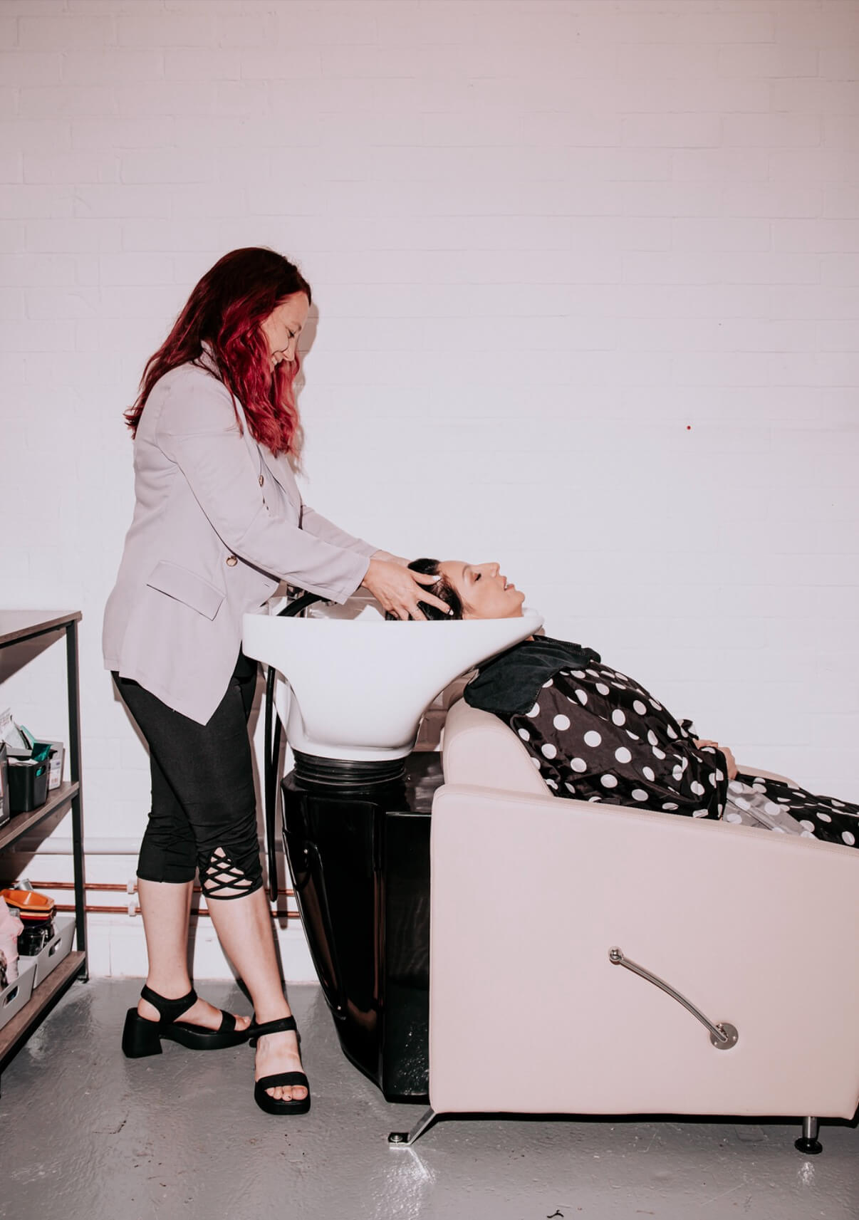 Olivia washing a client's hair at The Liv Bridal Hair Studio