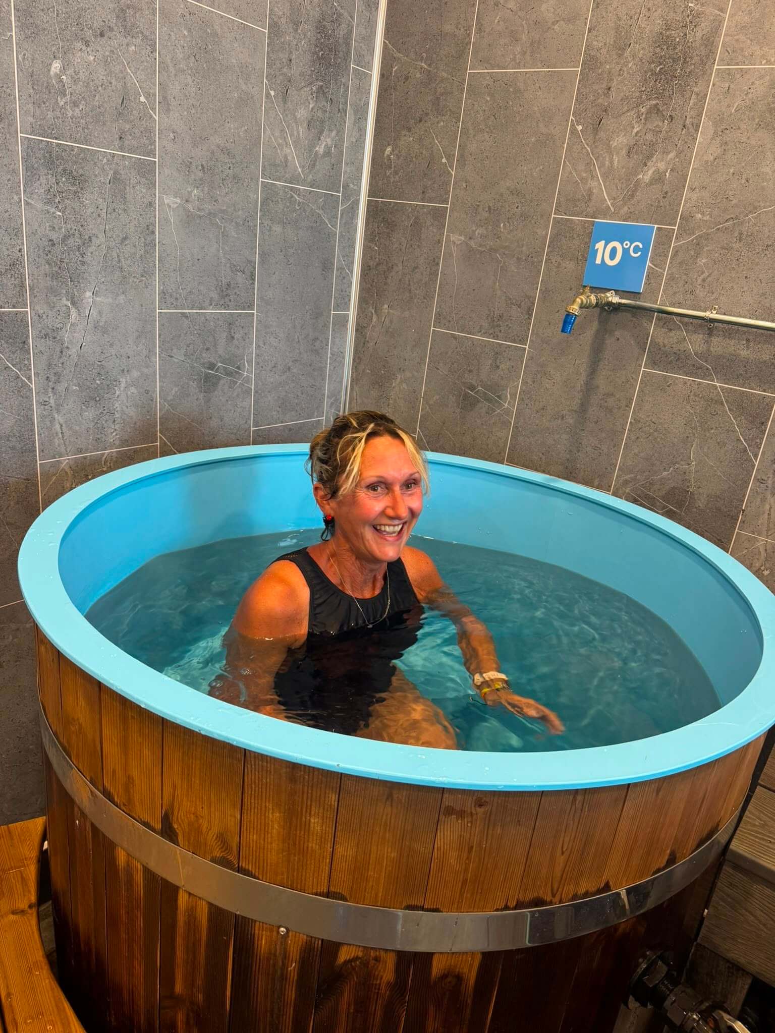 Liz Dando completing an ice bath plunge, the final challenge of her octathlon