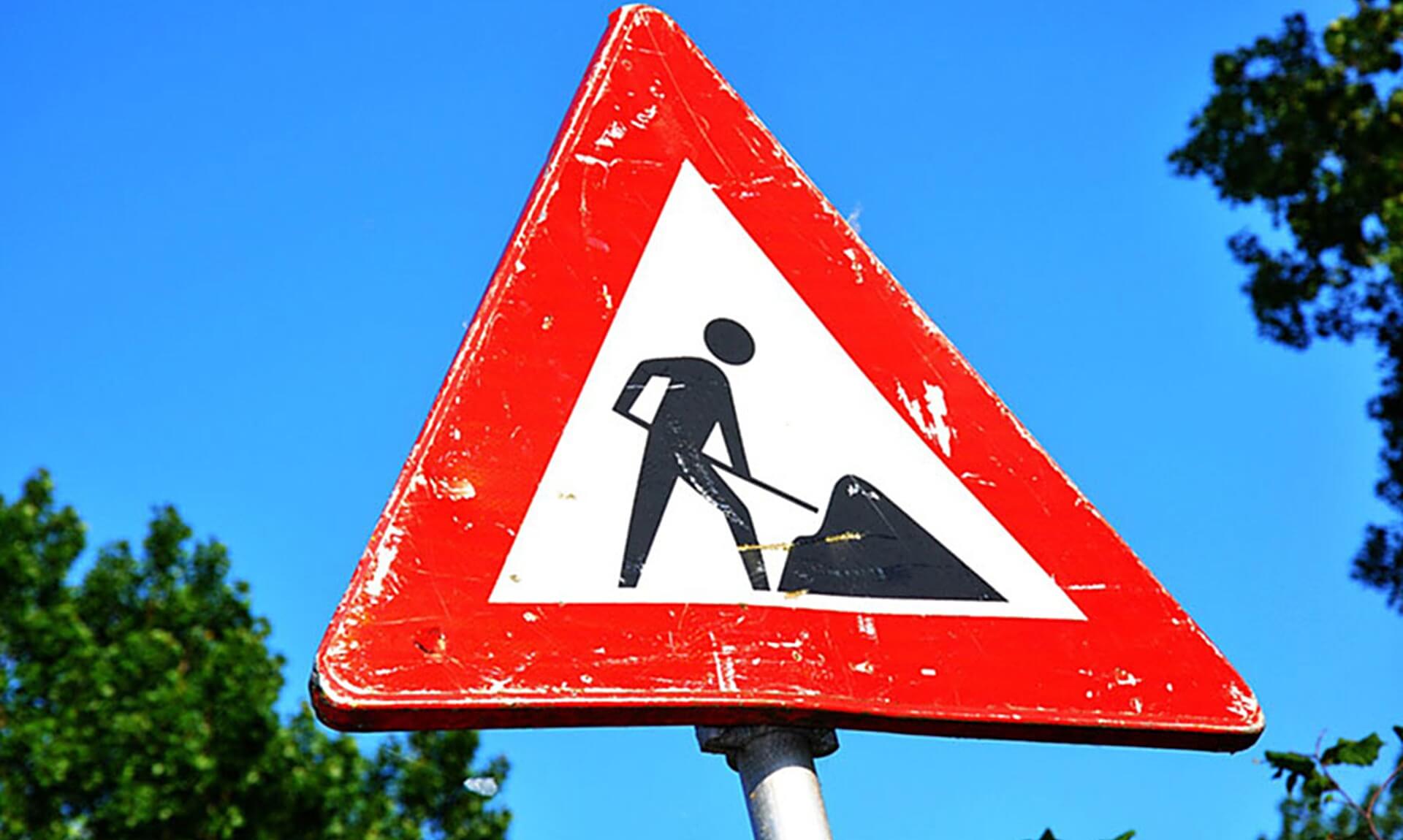 Roadworks sign against a blue sky