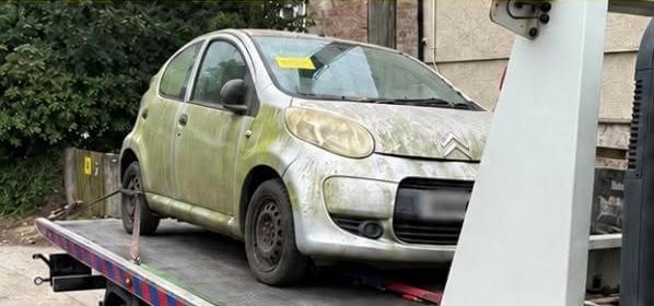 Silver Citroen hatchback with expired tax loaded onto a recovery lorry in Ludgvan