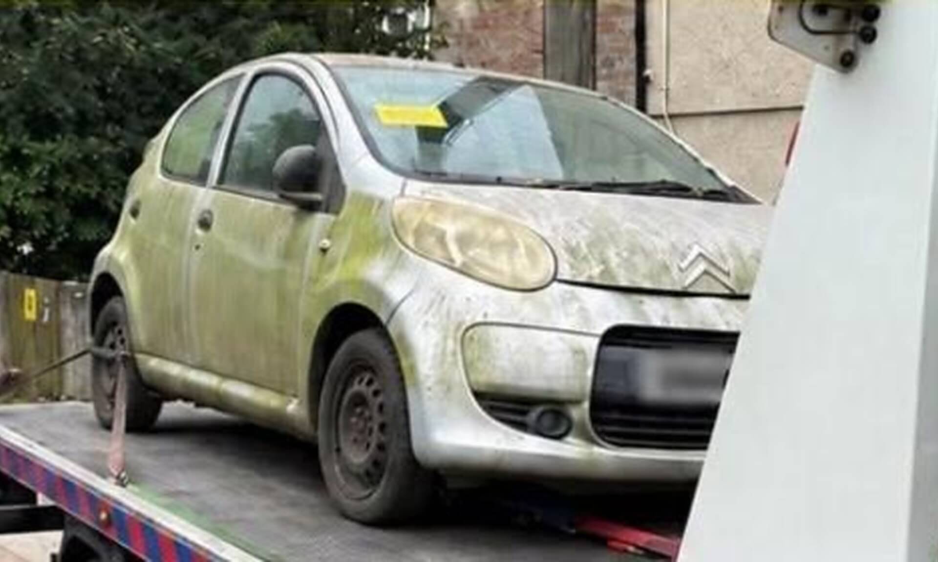 Silver Citroen hatchback with expired tax loaded onto a recovery lorry in Ludgvan