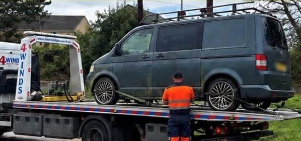 Dark VW van loaded onto a recovery lorry after being seized as untaxed