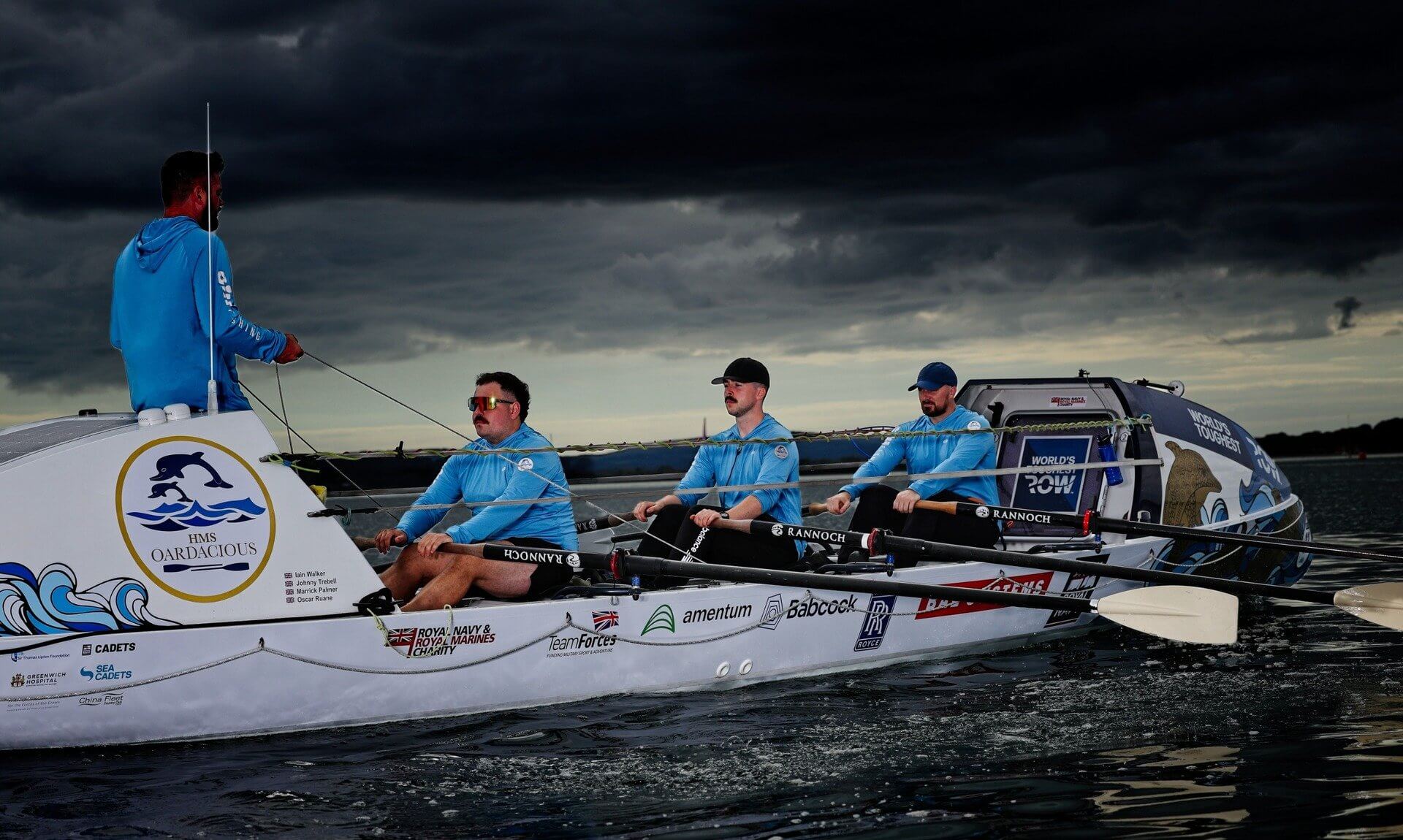 The HMS Oardacious crew rowing under storm clouds