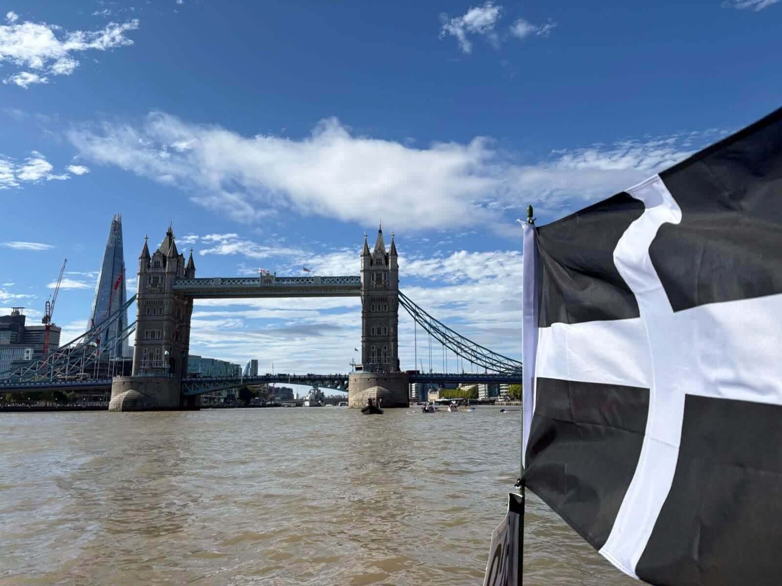 Tower Bridge seen from the Thames with a Cornish flag flying in the foreground