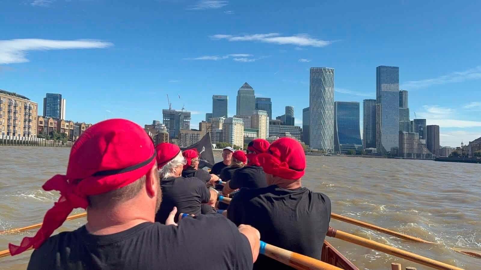 Mevagissey crew rowing towards the Canary Wharf skyline