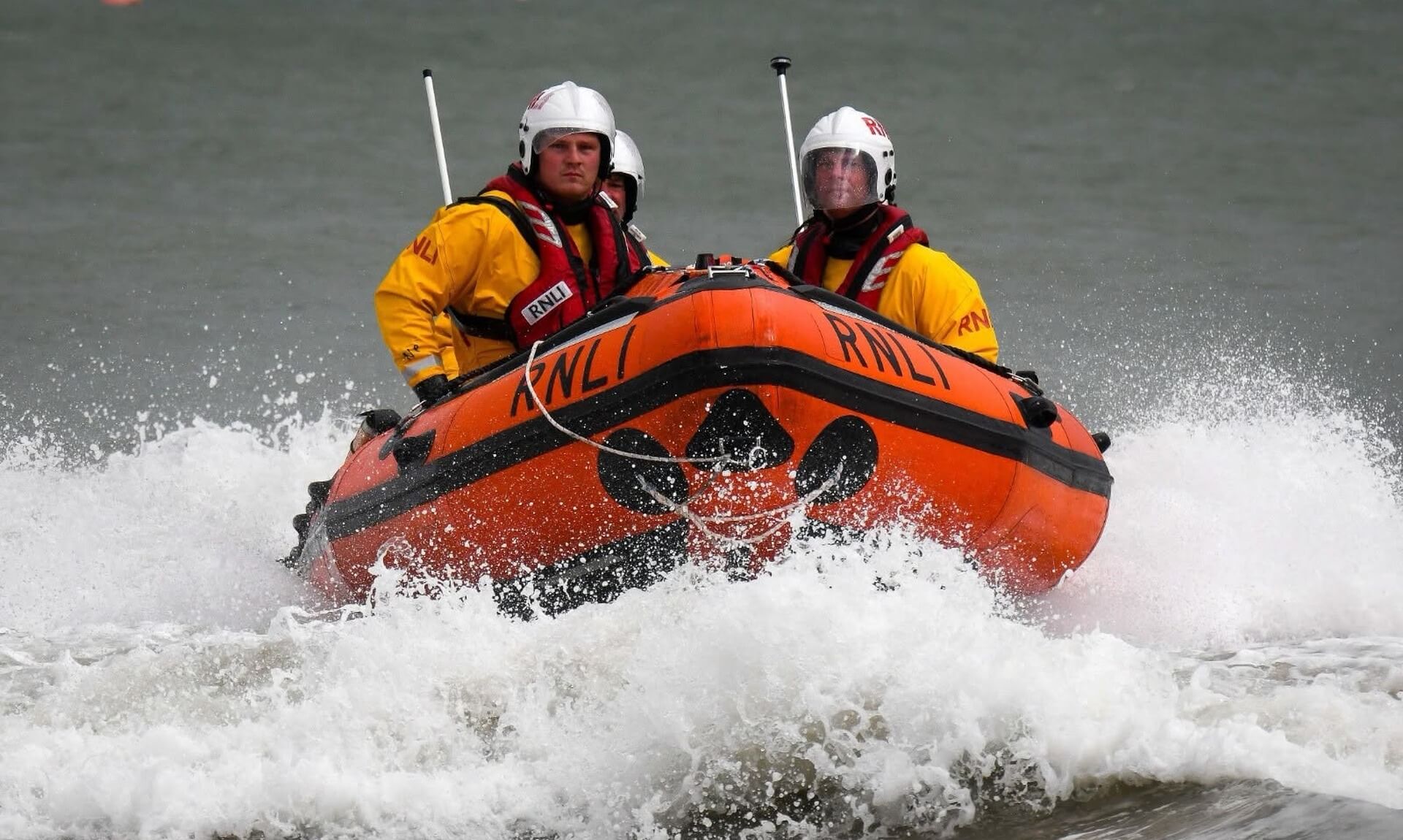 Newquay RNLI lifeboat crew powering through waves during a rescue