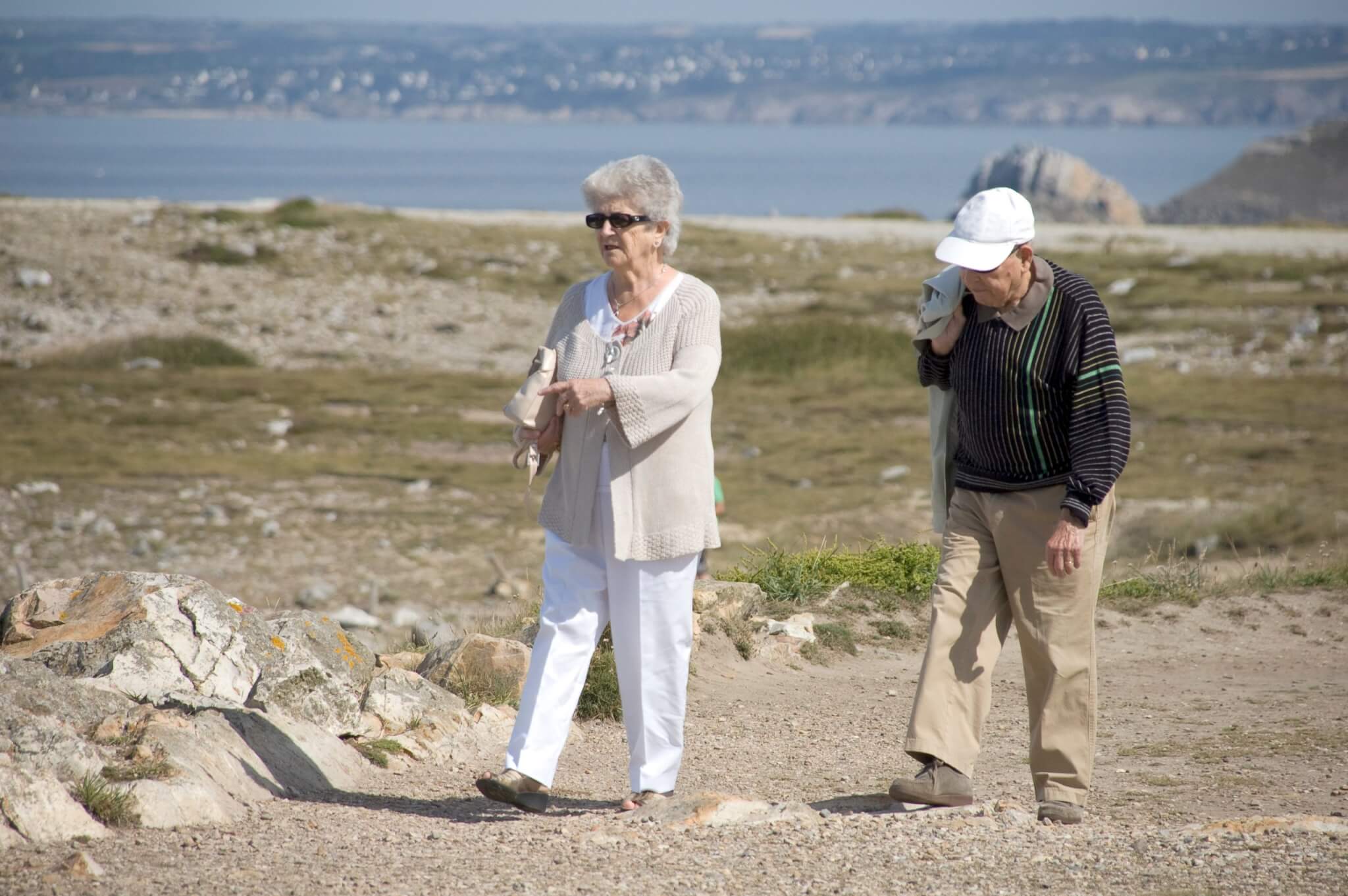 Older couple walking on a coastal clifftop path