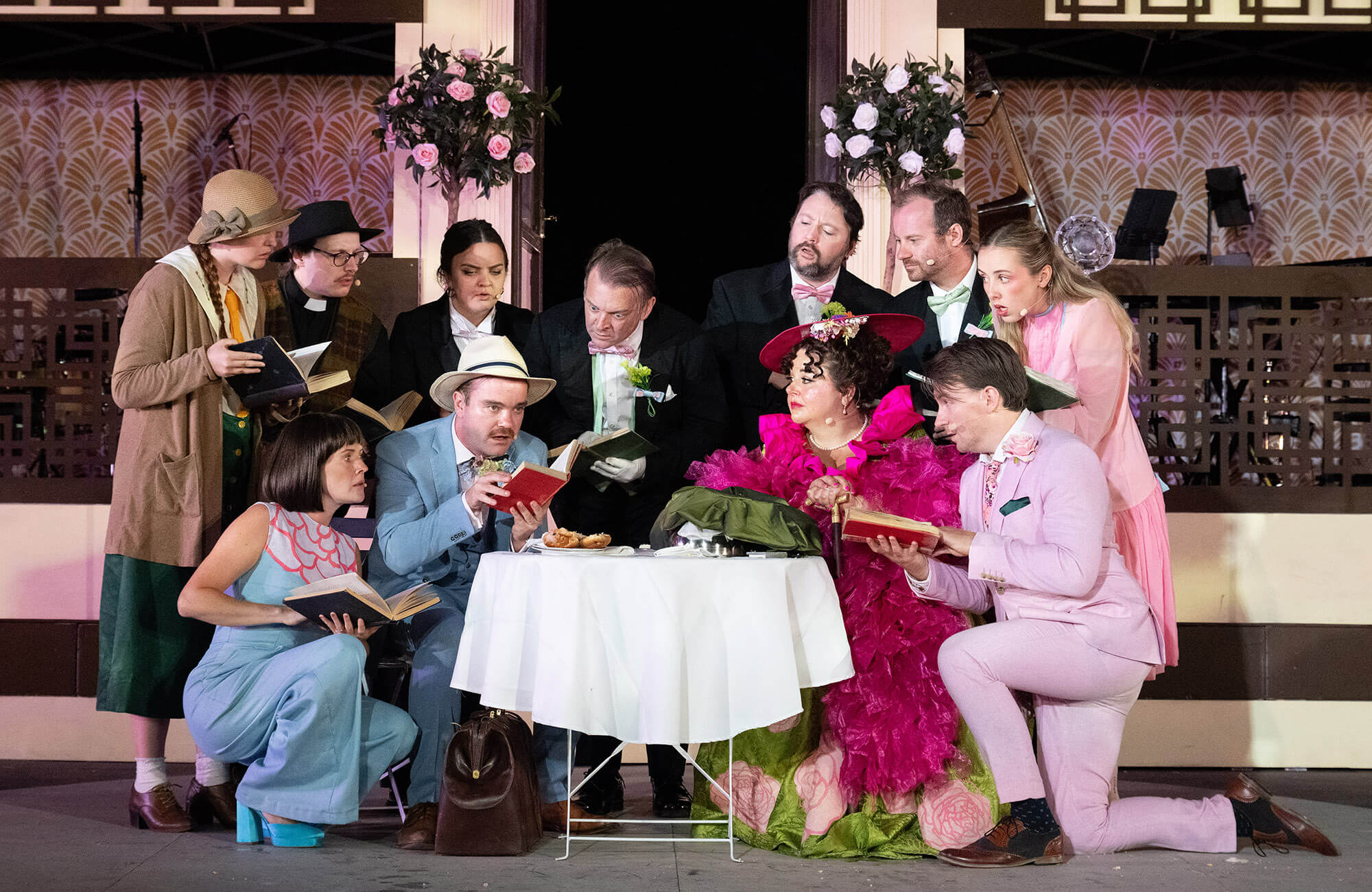 Full cast of OVO's 1920s Importance of Being Earnest around a table at the Minack Theatre