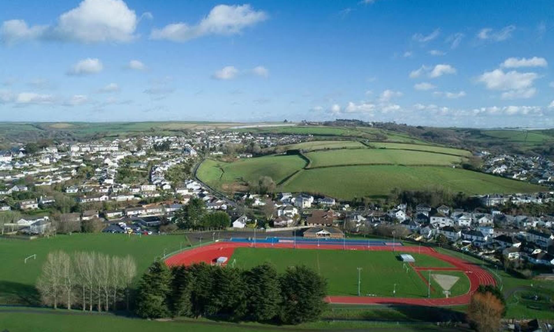 Aerial view of Par Track's athletics track and the village of Par