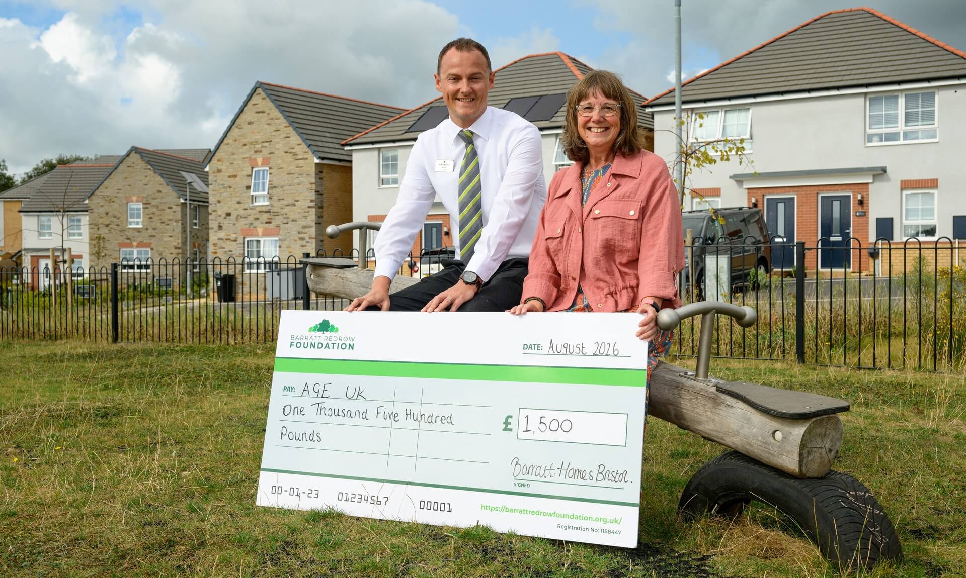 Michael Hyatt of Barratt Bristol and Kim Carey of Age UK Cornwall & The Isles of Scilly holding a giant cheque for £1,500
