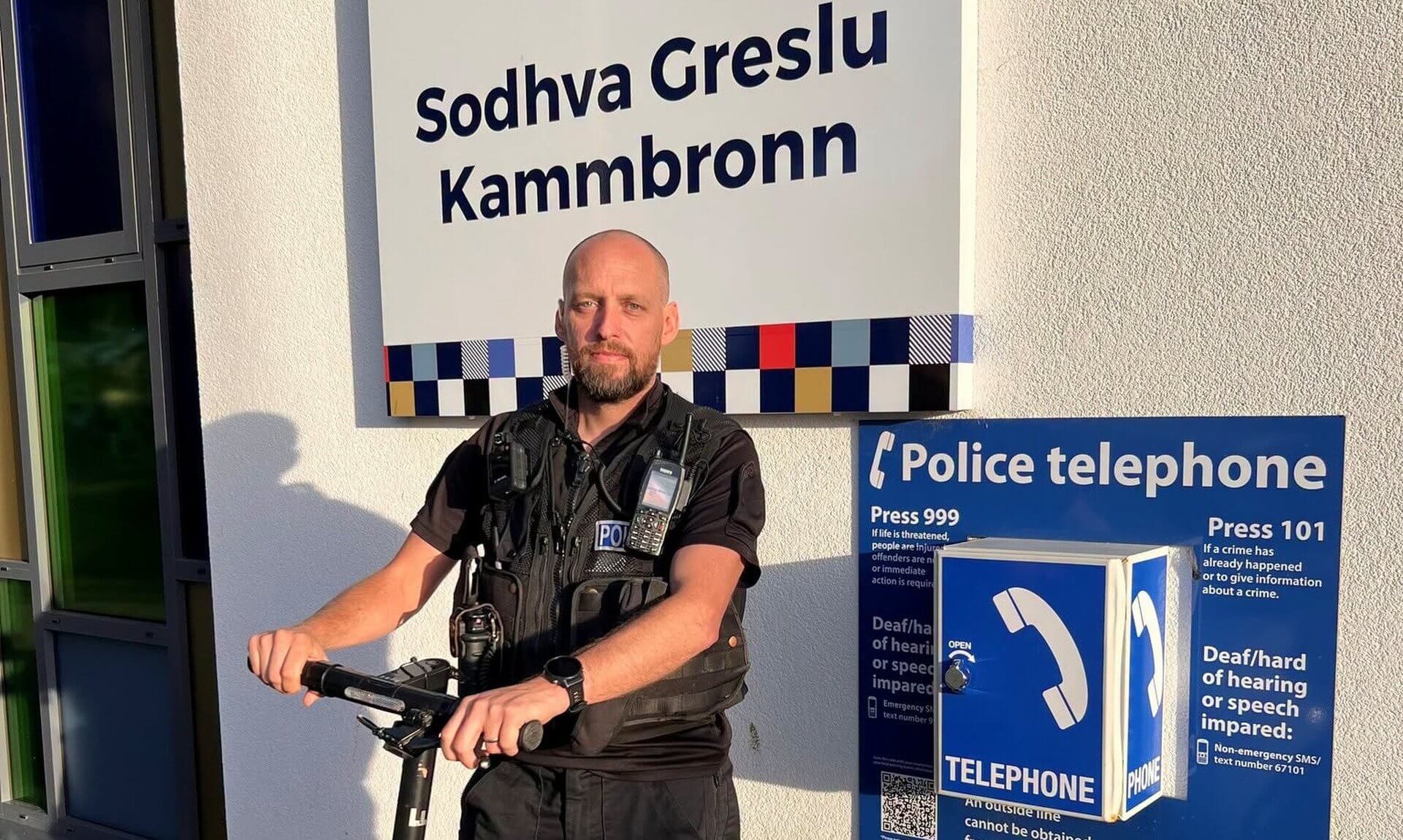 Police officer with a seized electric scooter outside Camborne Police Station