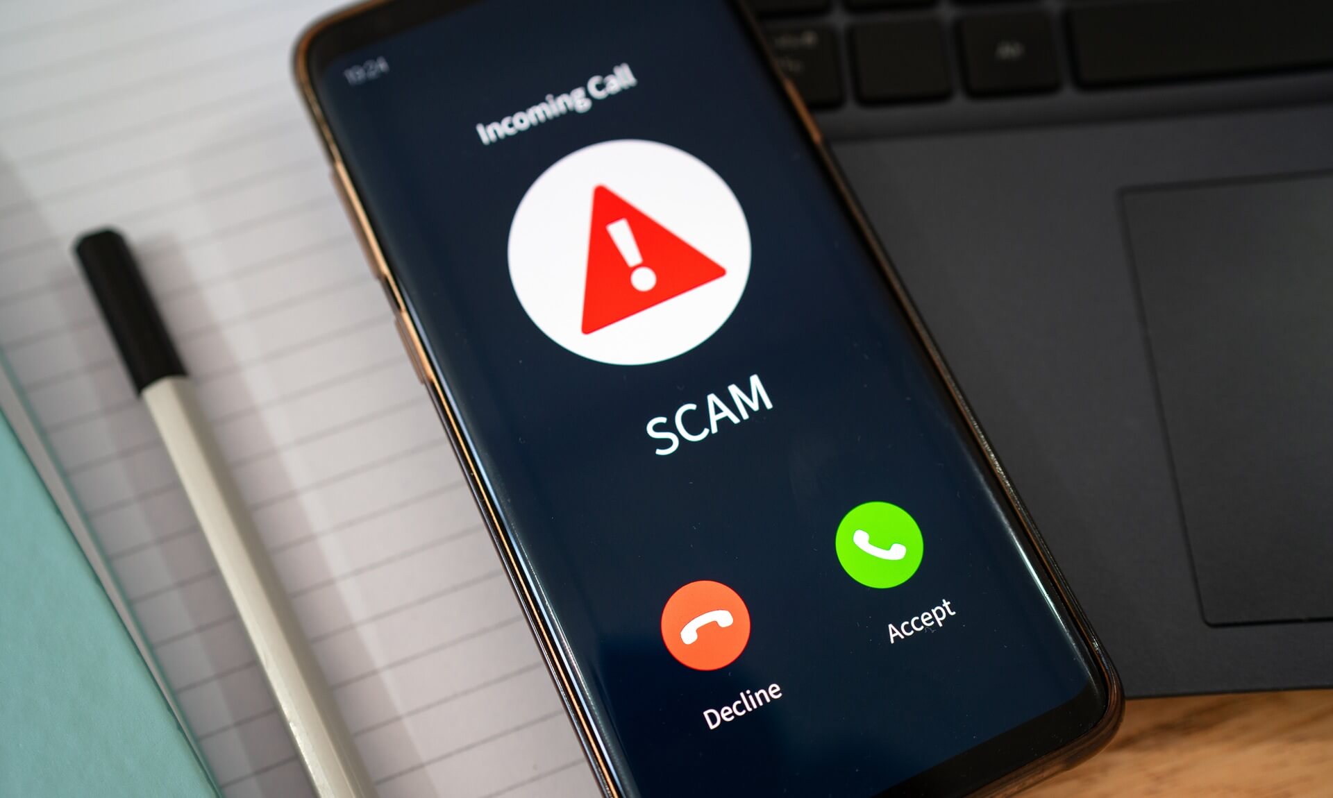 Smartphone showing an incoming call flagged as a scam