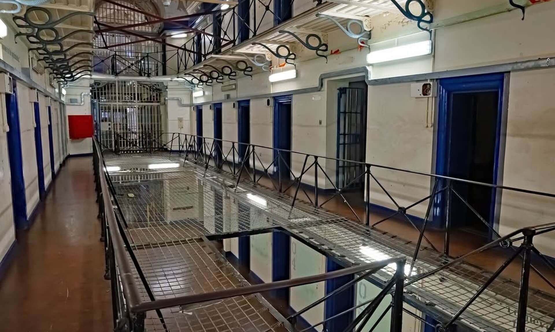 Landing of a Cornish prison wing with cell doors and railings
