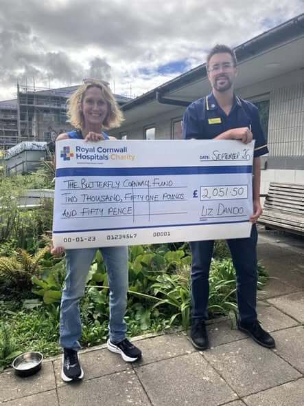 Liz Dando presenting a cheque for £2,051.50 to Todd Harris of the SPEOL Team