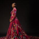 Lekazia Turner wearing The Red Dress with its long embroidered train