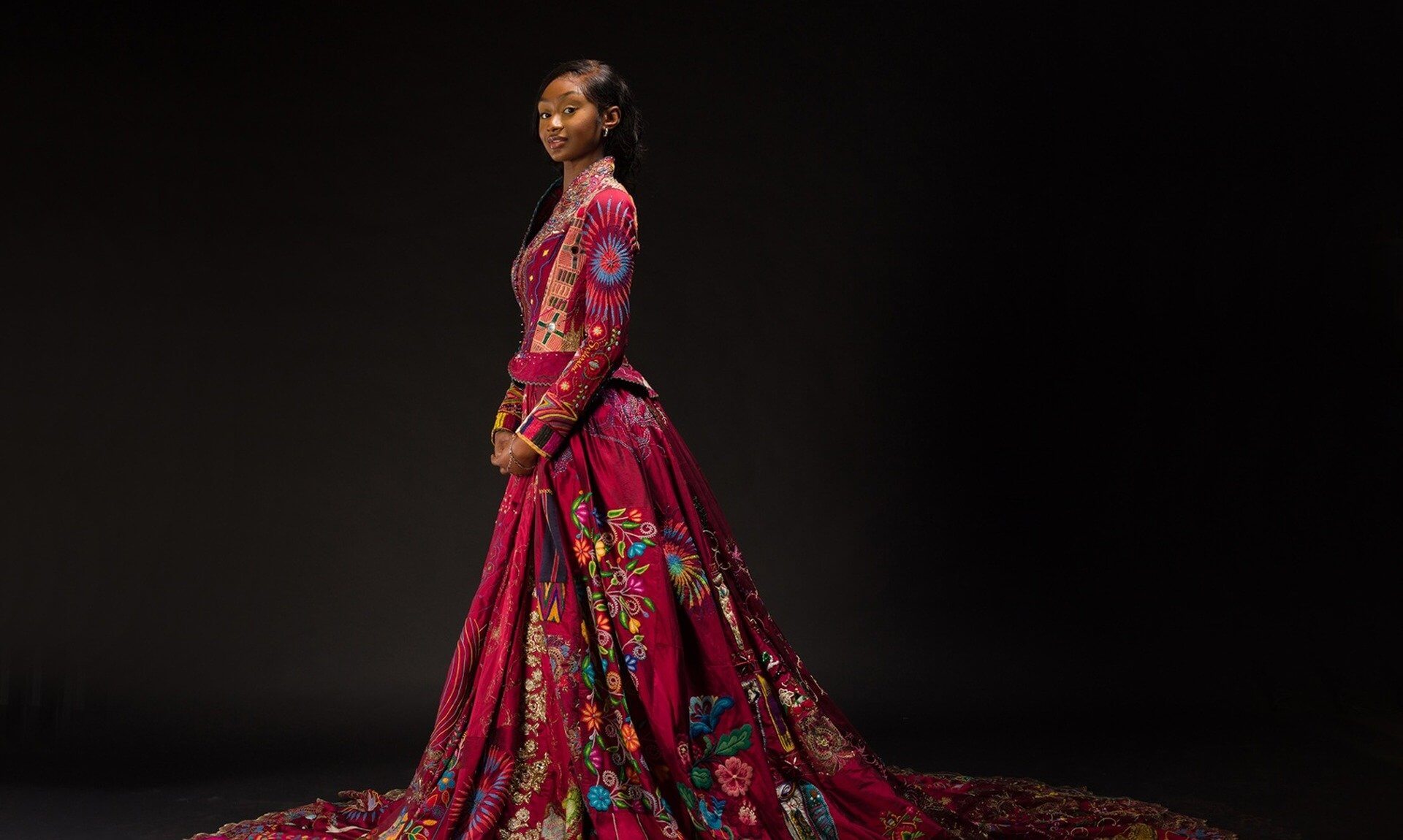 Lekazia Turner wearing The Red Dress with its long embroidered train