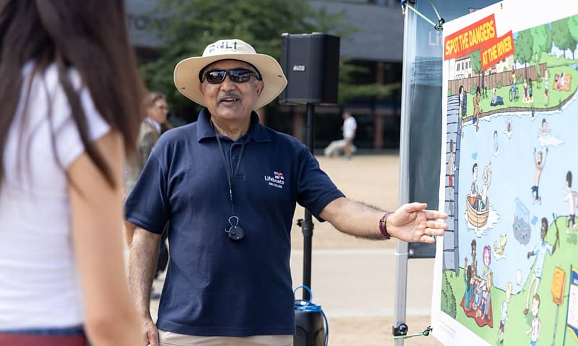 RNLI volunteer talking to a member of the public about water safety