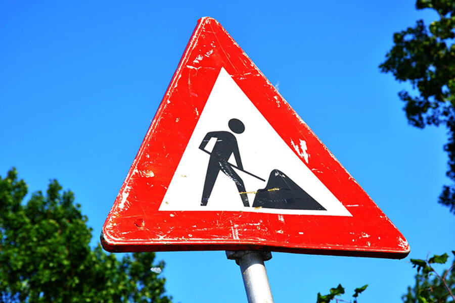 Roadworks sign against a blue sky