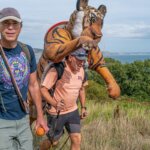 Simon Reeve and Paul Goldstein walking a coastal path with the tiger costume