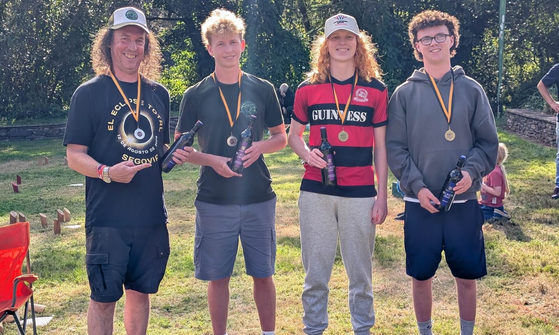 Doubles champions and runners-up holding wine bottles and medals at the World Smite Championships