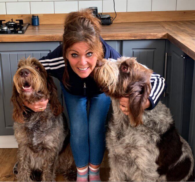 Tracey Ceaton in her kitchen with her two Italian Spinones