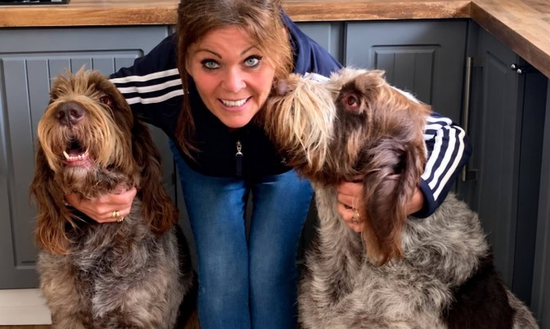 Tracey Ceaton in her kitchen with her two Italian Spinones