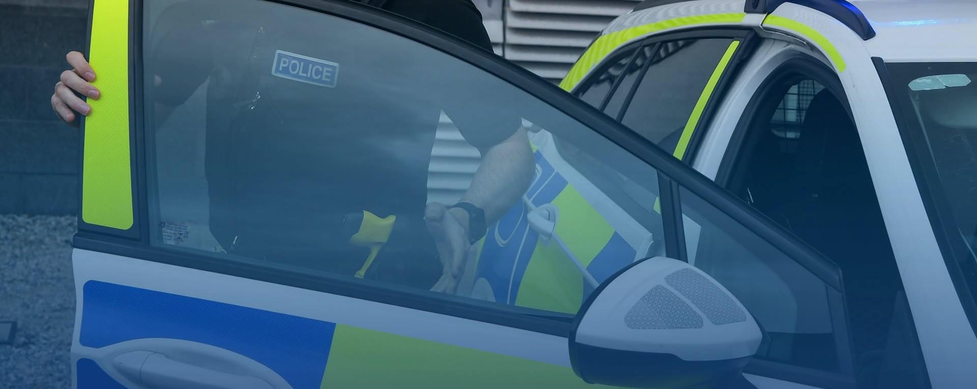 Devon and Cornwall Police officer at a police car