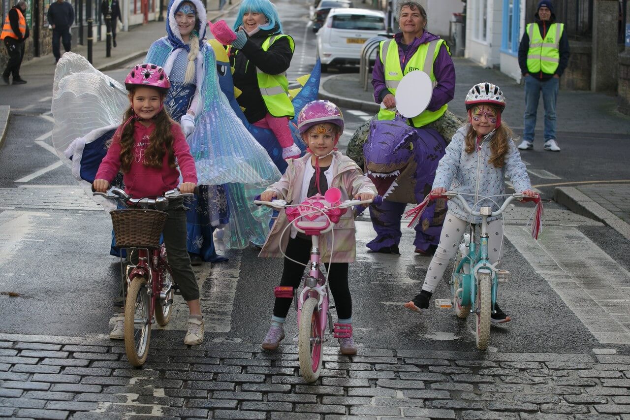 Children in costume riding bikes for the Twinkling Stars on Trikes race in Camborne