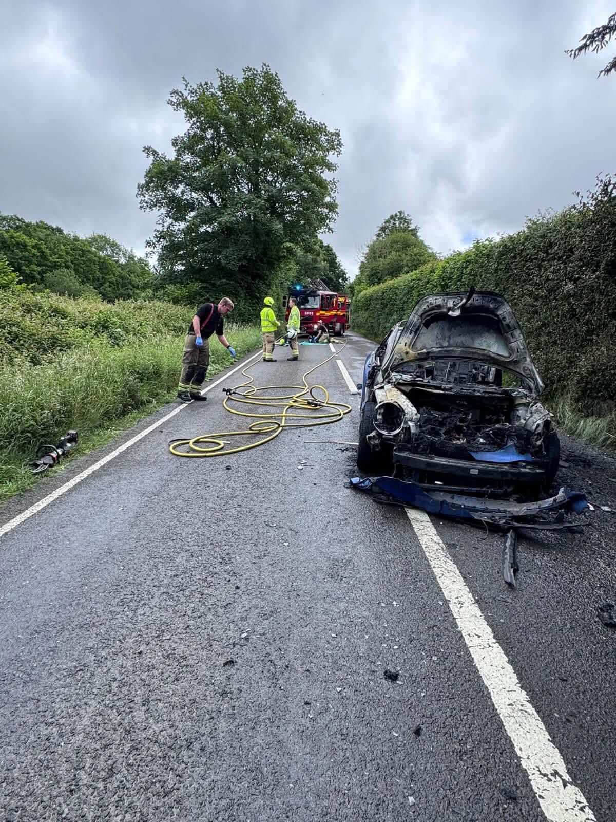 Burnt-out car at the roadside after a fire