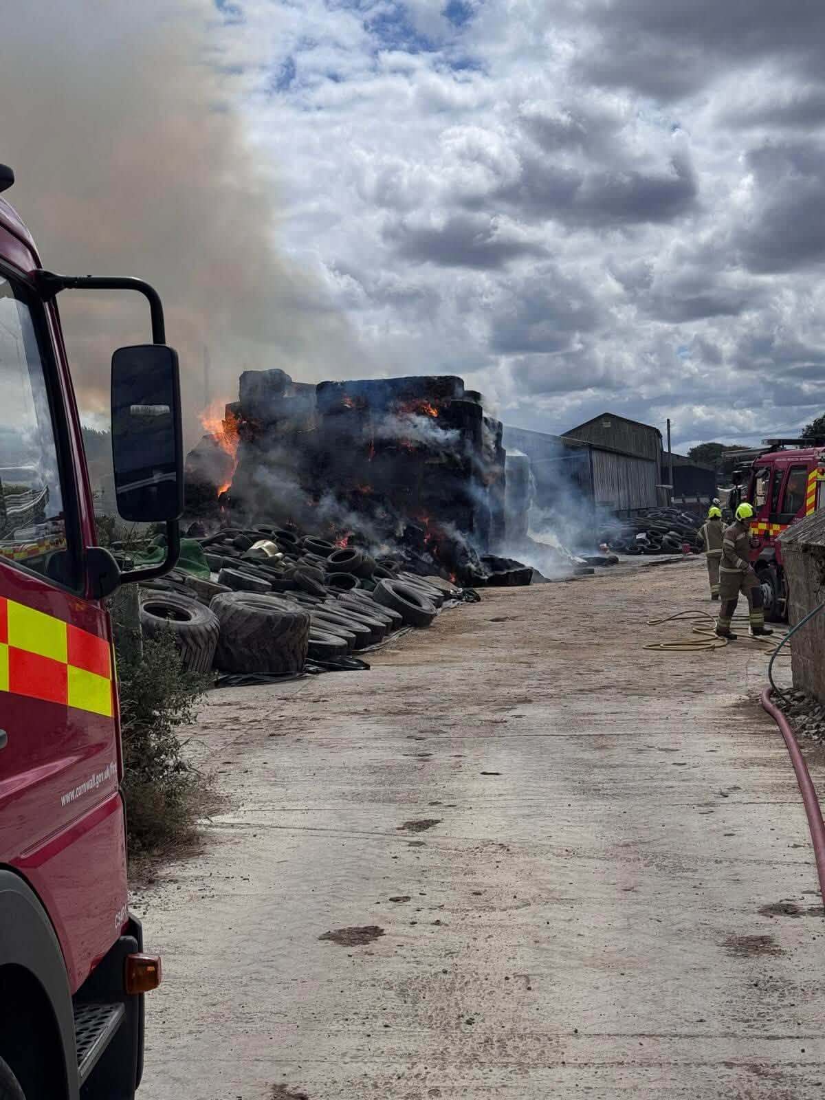 Farm fire involving stacked tyres and bales