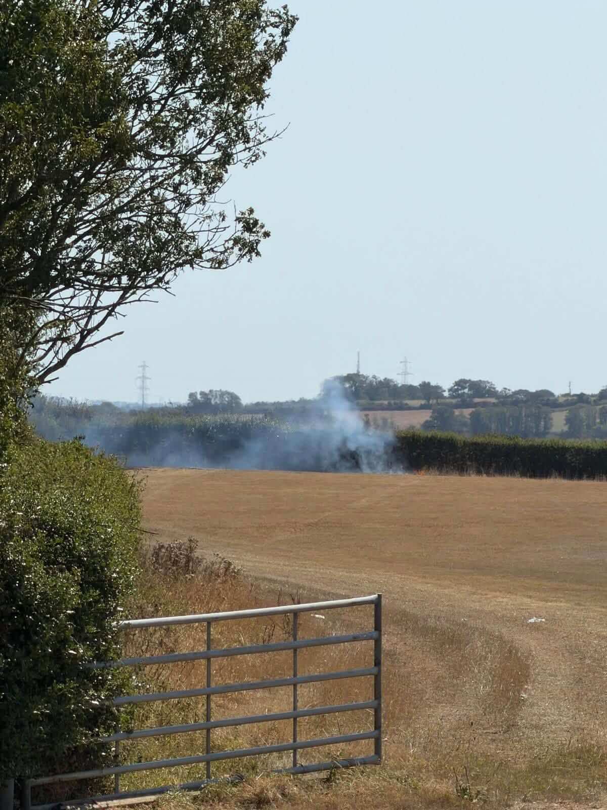 Smoke rising from a distant field fire