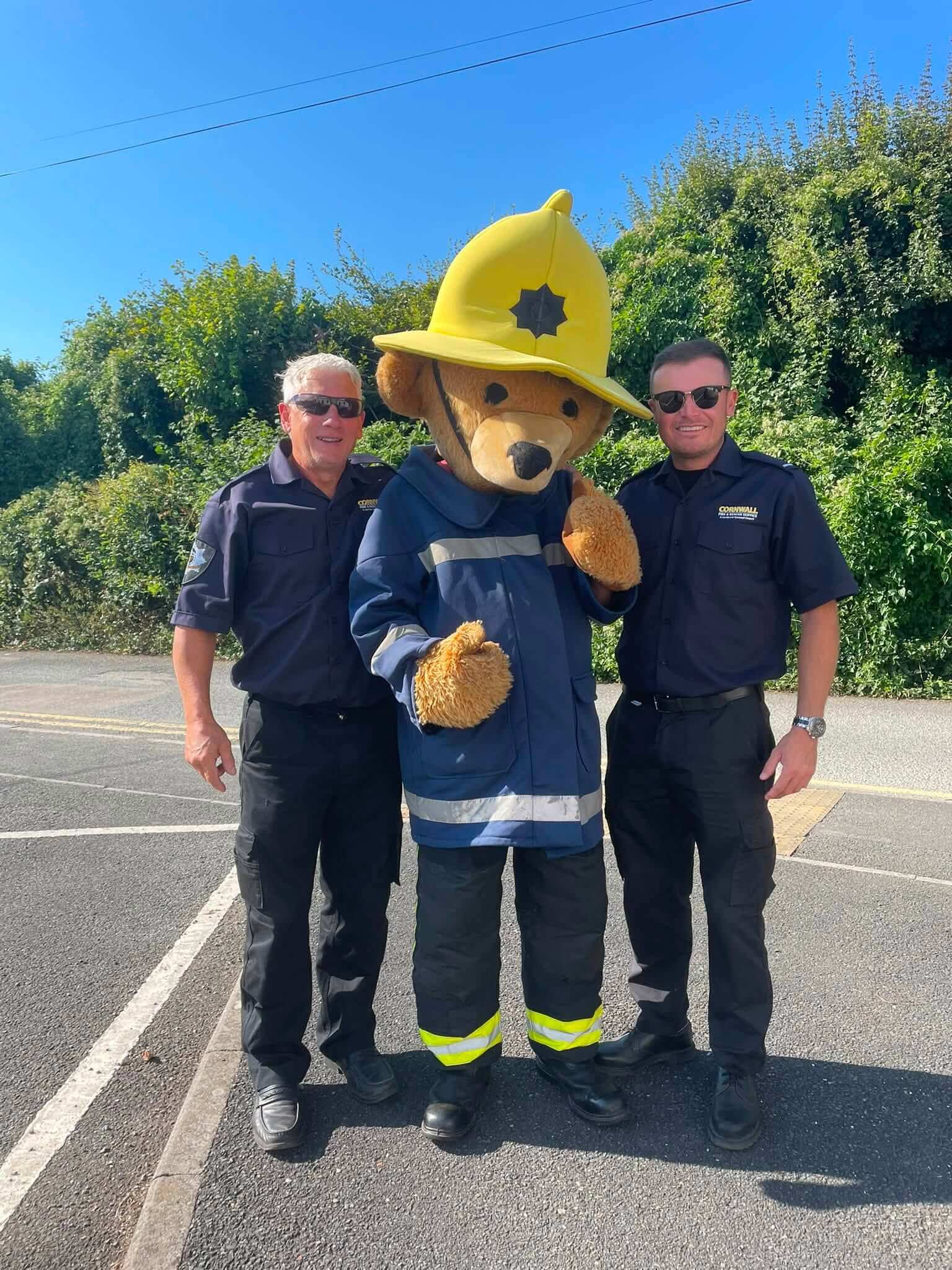 Fire safety bear mascot with two Cornwall Fire and Rescue Service officers