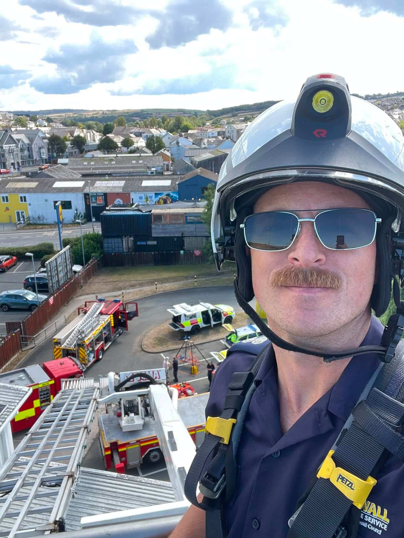 Firefighter on an aerial ladder platform above Wadebridge