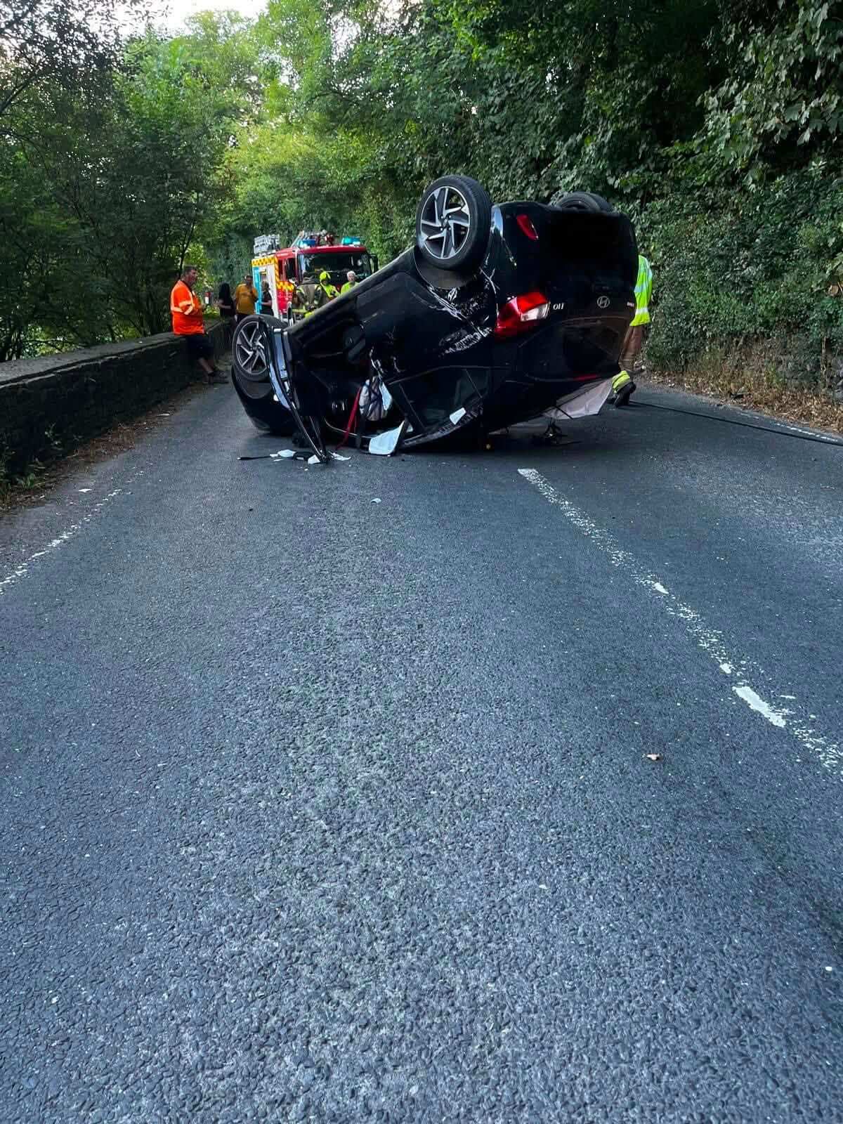 Overturned car on a country road after a collision