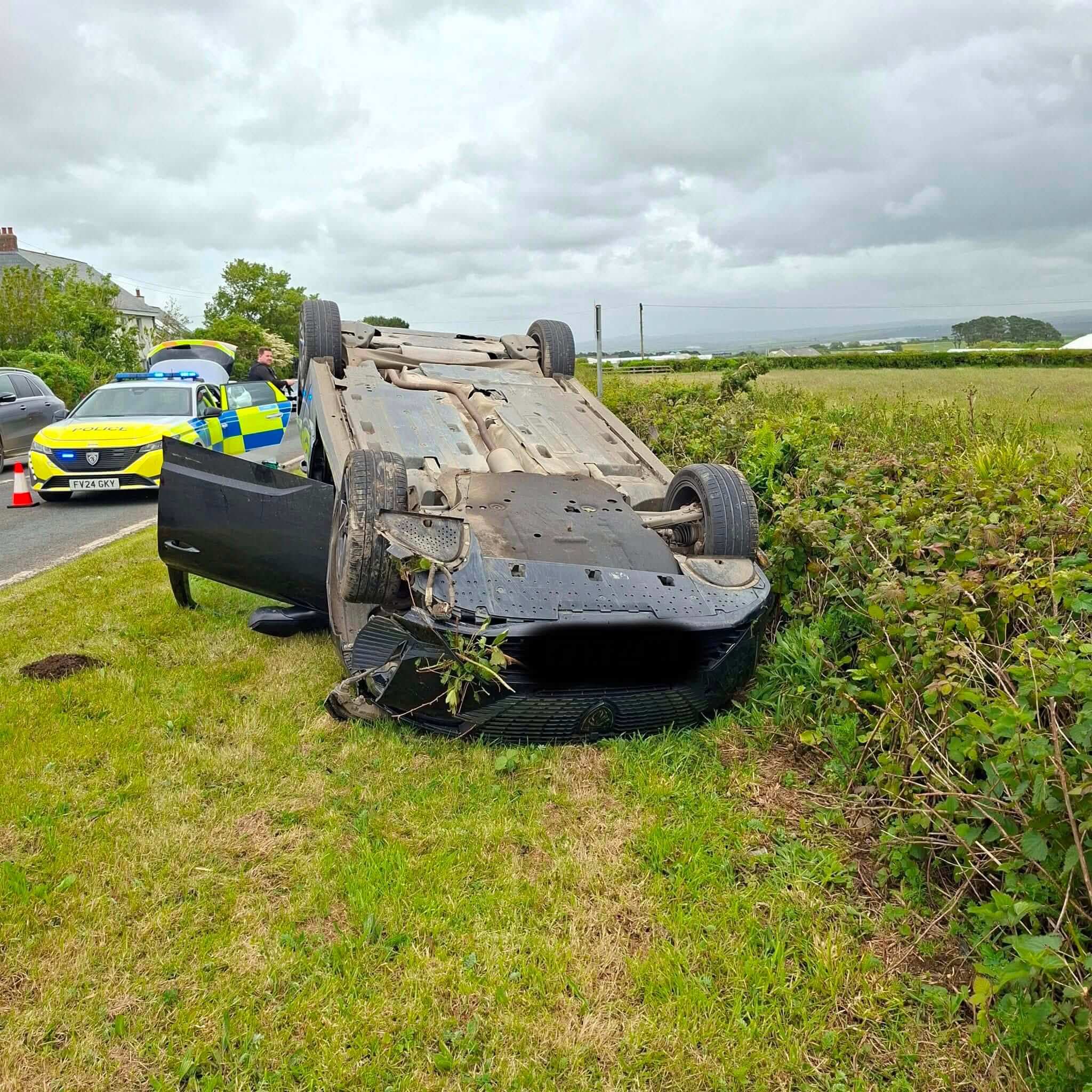 Overturned car with police and fire crews in attendance